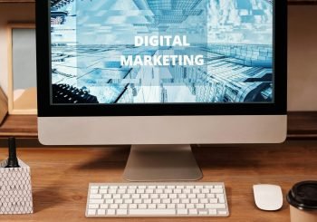Contemporary office setup featuring digital marketing strategy on a computer screen, ideal for business technology themes.